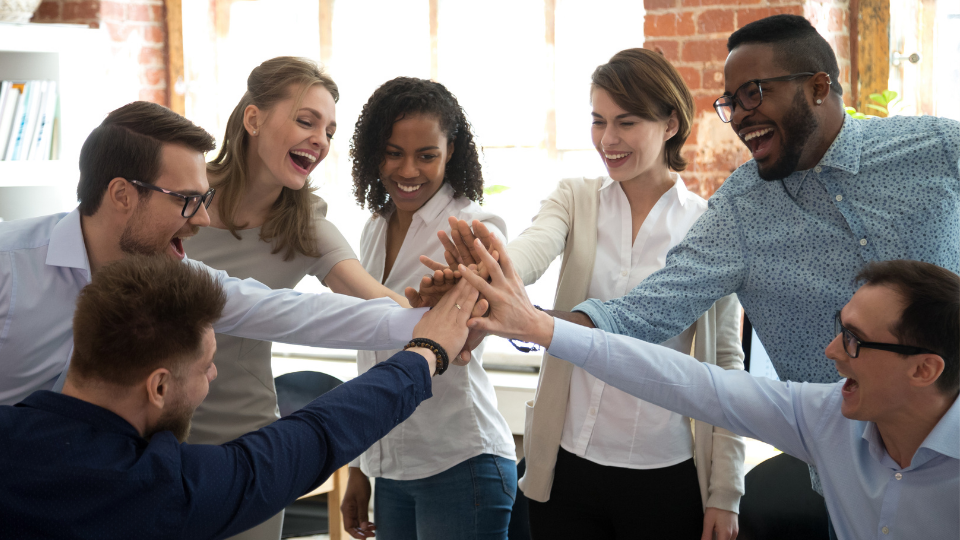 A group of employees celebrating a victory together.