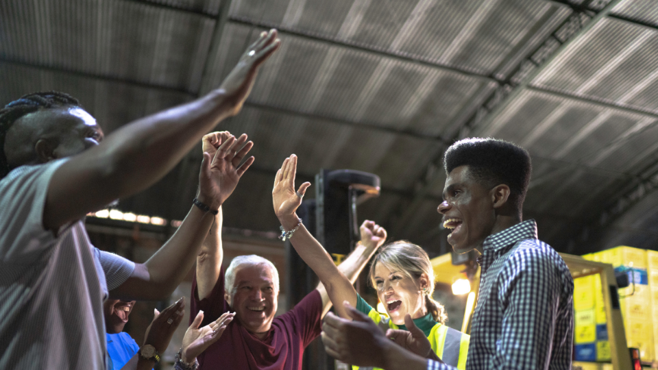 A group of logistic employees celebrating an accomplishment