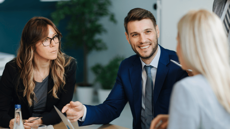Group of professionals in a business meeting discussing loan options, representing guidance and strategies for securing business loans with bad credit.