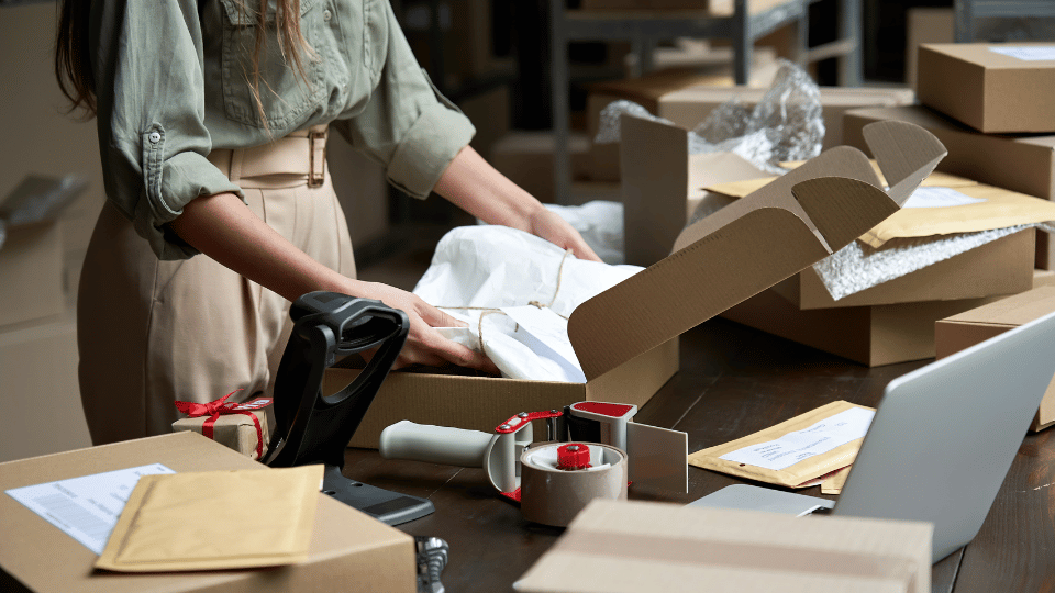 A business owner packing her products