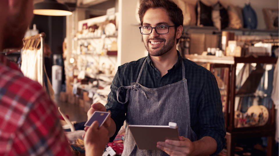 A salesperson closing a sale by shaking a customer's hand