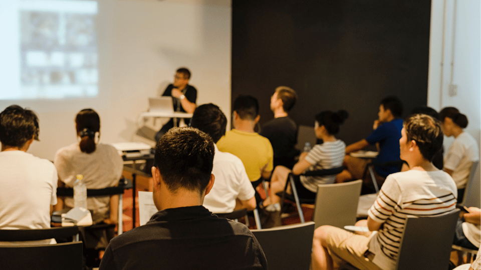 A group of employees attending a training about technology at their work